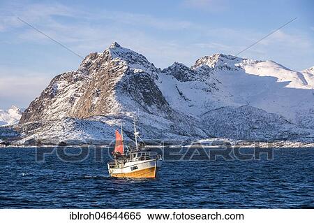 Traditional fishing boat catching the net, snowy mountains in the background, Lofoten, Norway, Europe View Large Photo Image Stock Photography - Traditional fishing boat catching the net, snowy mountains in the background, Lofoten, Norway, Europe. Fotosearch
