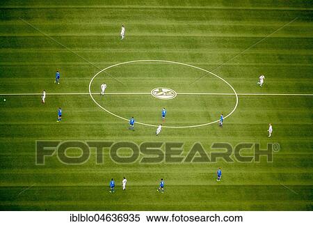 Stock Photography - Training ground, football pitch with Schalke emblem and training players, Gelsenkirchen, North Rhine-Westphalia, Germany, Europe. Fotosearch