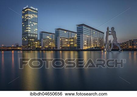 Treptowers and Molecule Men monument in the river Spree during blue hour, Berlin-Treptow, Berlin, Germany, Europe View Large Photo Image Stock Photograph - Treptowers and Molecule Men monument in the river Spree during blue hour, Berlin-Treptow, Berlin, Germany, Europe. Fotosearch