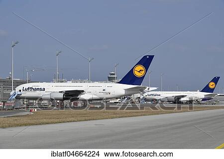 Two Airbus, A380-800, Lufthansa, in parking position, with tower, Munich Airport, Upper Bavaria, Bavaria, Germany, Europe View Large Photo Image Picture - Two Airbus, A380-800, Lufthansa, in parking position, with tower, Munich Airport, Upper Bavaria, Bavaria, Germany, Europe. Fotosearch