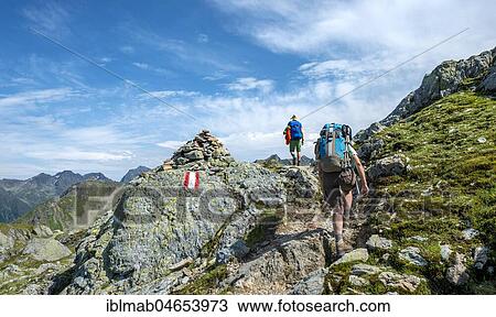 Stock Image - Two hikers on Schladminger Höhenweg, Schladminger Tauern, Schladming, Styria, Austria, Europe. Fotosearch
