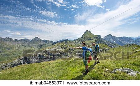 Two hikers point to the distance, Schladminger Höhenweg, Schladminger Tauern, Schladming, Styria, Austria, Europe View Large Photo Image Stock Image - Two hikers point to the distance, Schladminger Höhenweg, Schladminger Tauern, Schladming, Styria, Austria, Europe. Fotosearch