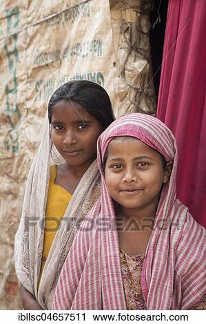 Two little girls, smiling, in the slum at the Ghazipur garbage dump, portrait, New Delhi, India, Asia View Large Photo Image Stock Image - Two little girls, smiling, in the slum at the Ghazipur garbage dump, portrait, New Delhi, India, Asia. Fotosearch