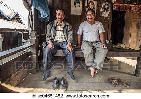 Two locals are sitting in their hut, Preah Meas, Sen Monorom, Mondulkiri, Cambodia, Asia View Large Photo Image Stock Image - Two locals are sitting in their hut, Preah Meas, Sen Monorom, Mondulkiri, Cambodia, Asia. Fotosearch