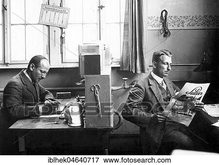 Two men in the office, one working, one reading newspaper, 1926, exact location unknown, Germany, Europe View Large Photo Image Stock Photo - Two men in the office, one working, one reading newspaper, 1926, exact location unknown, Germany, Europe. Fotosearch