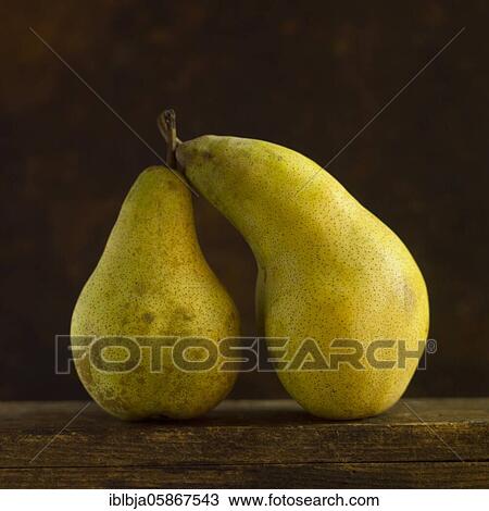 Stock Image - Two pears on black background, studio shot, France, Europe. Fotosearch