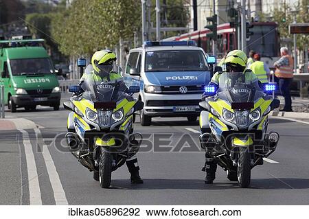 Two policemen on motorcycles and crew cars, used at a demonstration against corona rules, Düsseldorf, North Rhine-Westphalia, Germany, Europe View Large Photo Image Stock Image - Two policemen on motorcycles and crew cars, used at a demonstration against corona rules, Düsseldorf, North Rhine-Westphalia, Germany, Europe. Fotosearch