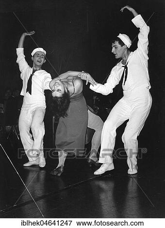 Stock Photo - Two sailors dancing with woman in evening gown, 1960s, Berlin, Germany, Europe. Fotosearch