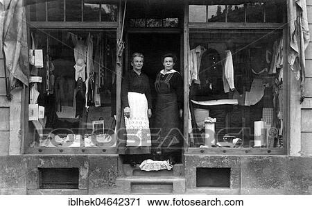 Two saleswomen are standing in the door of their fashion shop, 1930s, Germany, Europe View Large Photo Image Stock Image - Two saleswomen are standing in the door of their fashion shop, 1930s, Germany, Europe. Fotosearch