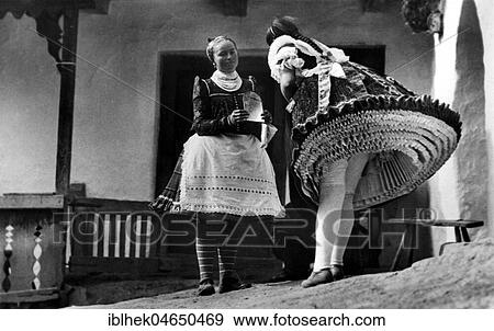 Stock Photo - Two women in traditional costumes with many petticoats, 1930s, Germany, Europe. Fotosearch
