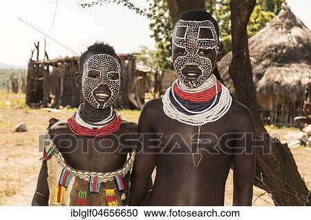 Two young girls with face painting, Karo tribe, in the back Karo village, Southern Nations Nationalities and Peoples' Region, Ethiopia, Africa View Large Photo Image Stock Image - Two young girls with face painting, Karo tribe, in the back Karo village, Southern Nations Nationalities and Peoples' Region, Ethiopia, Africa. Fotosearch