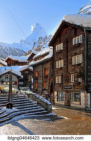 Typical old Valaisian houses at the church square in the back of Matterhorn 4478m, Zermatt, Mattertal, Valais, Switzerland, Europe View Large Photo Image Stock Image - Typical old Valaisian houses at the church square in the back of Matterhorn 4478m, Zermatt, Mattertal, Valais, Switzerland, Europe. Fotosearch