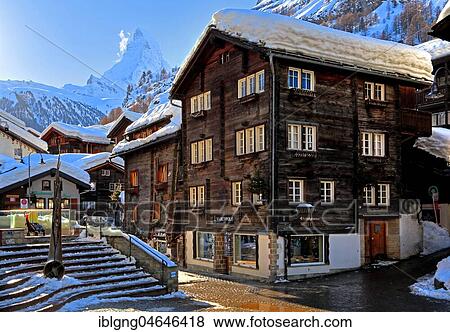 Typical old Valaisian houses at the church square in the back of Matterhorn 4478m, Zermatt, Mattertal, Valais, Switzerland, Europe View Large Photo Image Stock Photo - Typical old Valaisian houses at the church square in the back of Matterhorn 4478m, Zermatt, Mattertal, Valais, Switzerland, Europe. Fotosearch