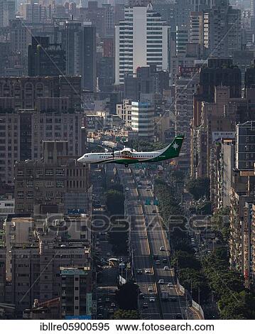 Stock Photography - Uni Air plane flies over urban area with streets and skyscrapers, Taipei, Taiwan, Asia. Fotosearch