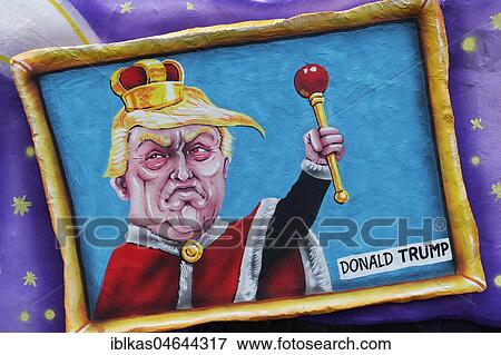 Stock Photo - US President Donald Trump as king with scepter in a picture frame, political caricature, motto caravan, motto caravan Carnival Monday procession 2018, Düsseldorf, North Rhine-Westphalia, Germany, Europe. Fotosearch