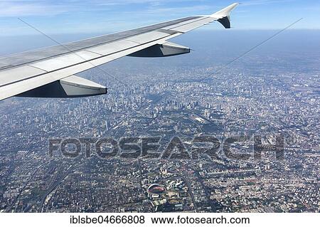 Stock Photo - View from a plane with wing on city centre, aerial view, Bangkok, Thailand, Asia. Fotosearch