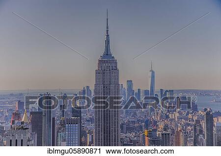 Stock Image - View from Rockefeller Center to the skyline of Manhattan. Skyscrapers, skyscraper, megacity, city, landmark, architecture, dusk, New York, America, United States, USA, North America. Fotosearch