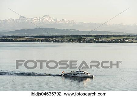 View of Lake Constance with excursion boat, in the back the Swiss Alps with Säntis, near Meersburg, Baden-Württemberg, Germany, Europe View Large Photo Image Stock Image - View of Lake Constance with excursion boat, in the back the Swiss Alps with Säntis, near Meersburg, Baden-Württemberg, Germany, Europe. Fotosearch