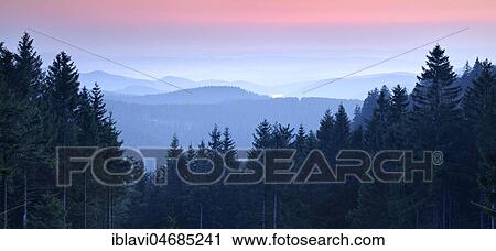 Stock Image - View over low mountain range landscape, hilly landscape with forests, sunset, valley fog, Harz National Park, Lower Saxony, Germany, Europe. Fotosearch