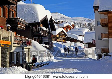Stock Image - Village road with snow-covered chalets, Bettmeralp, Aletsch area, Upper Valais, Valais, Switzerland, Europe. Fotosearch