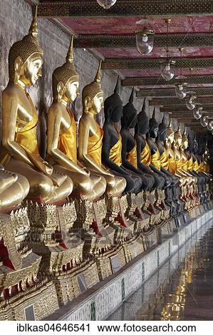 Wall with row of Buddha statues in meditation posture, on decorated pedestals, Phra Rabieng Kot, Wat Suhtat, Royal Temple, Phra Nakhon, Bangkok, Thailand, Asia View Large Photo Image Stock Image - Wall with row of Buddha statues in meditation posture, on decorated pedestals, Phra Rabieng Kot, Wat Suhtat, Royal Temple, Phra Nakhon, Bangkok, Thailand, Asia. Fotosearch
