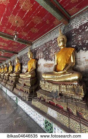 Wall with row of golden Buddha statues in meditation posture, on decorated pedestals, Phra Rabieng Kot, Wat Suhtat, royal temple, Phra Nakhon, Bangkok, Thailand, Asia View Large Photo Image Stock Photography - Wall with row of golden Buddha statues in meditation posture, on decorated pedestals, Phra Rabieng Kot, Wat Suhtat, royal temple, Phra Nakhon, Bangkok, Thailand, Asia. Fotosearch