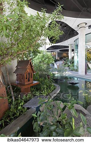 Water Garden with ghost house, San Phra Phum, in the European quarter, Emporium, Luxury Shopping Mall, Sukhumvit Road, Khlong Toei, Bangkok, Thailand, Asia View Large Photo Image Stock Image - Water Garden with ghost house, San Phra Phum, in the European quarter, Emporium, Luxury Shopping Mall, Sukhumvit Road, Khlong Toei, Bangkok, Thailand, Asia. Fotosearch