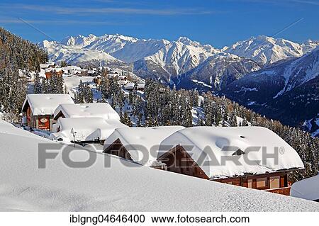Stock Image - Winter landscape with snow-covered chalets, in the back Ober Rappehorn, 3176m and Gross Schinhorn, 2939m, Riederalp, Aletsch area, Upper Valais, Valais, Switzerland, Europe. Fotosearch
