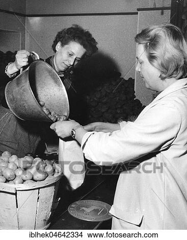 Picture - Woman buys potatoes, 1960s, Germany, Europe. Fotosearch