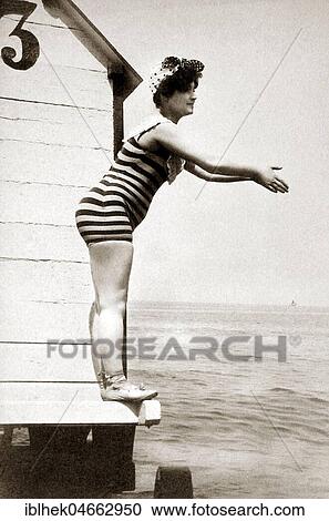 Woman in striped swimsuit wants to jump into the water, 1910s, Baltic Sea, Germany, Europe View Large Photo Image Stock Image - Woman in striped swimsuit wants to jump into the water, 1910s, Baltic Sea, Germany, Europe. Fotosearch
