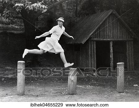 Stock Photo - Woman jumps from peg to peg, 1930s, exact place unknown, Germany, Europe. Fotosearch