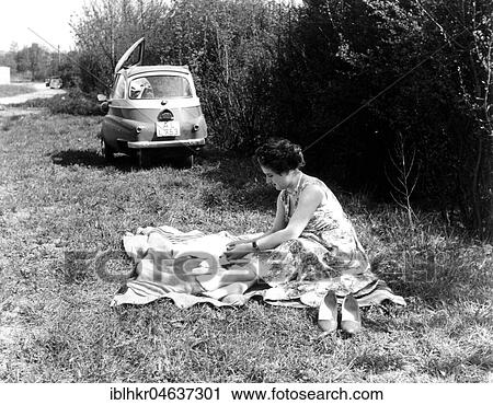 Woman making picnic, in the background an Isetta, 1950s, ca. 1959, exact place unknown, Germany, Europe View Large Photo Image Stock Image - Woman making picnic, in the background an Isetta, 1950s, ca. 1959, exact place unknown, Germany, Europe. Fotosearch