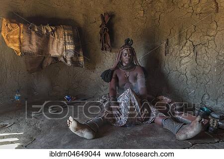 Woman of the Ovahimba or Himba people cleaning and disinfecting clothes and body, Kunene district, Namibia, Africa View Large Photo Image Picture - Woman of the Ovahimba or Himba people cleaning and disinfecting clothes and body, Kunene district, Namibia, Africa. Fotosearch