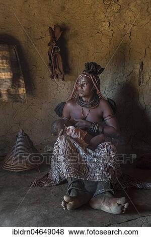 Woman of the people of Ovahimba or Himba suckling toddler in a hut, Kunene district, Namibia, Africa View Large Photo Image Stock Photo - Woman of the people of Ovahimba or Himba suckling toddler in a hut, Kunene district, Namibia, Africa. Fotosearch