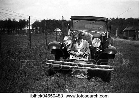 Stock Image - Woman posing in front of a car, 1920s, Germany, Europe. Fotosearch