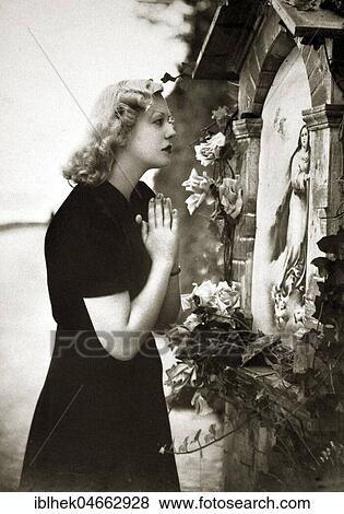 Woman praying in front of Virgin Mary picture, 1920s, Germany, Europe View Large Photo Image Stock Photo - Woman praying in front of Virgin Mary picture, 1920s, Germany, Europe. Fotosearch