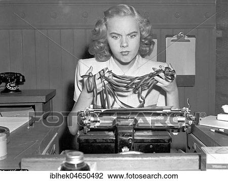 Woman, secretary, desperate on typewriter, knotted typewriter ribbon, 1940s, Germany, Europe View Large Photo Image Stock Image - Woman, secretary, desperate on typewriter, knotted typewriter ribbon, 1940s, Germany, Europe. Fotosearch