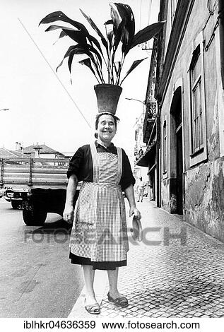 Stock Photo - Woman wears flowerpot on her head, ca. 1970s, exact place unknown, Germany, Europe. Fotosearch