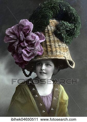 Stock Image - Woman with a basket as a hat, hat fashion, fashion satire, 1910s, Germany, Europe. Fotosearch