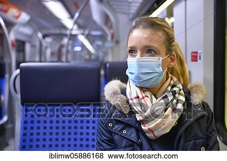 Stock Photo - Woman with a face mask sitting on a train, Corona crisis, Stuttgart, Baden-Württemberg, Germany, Europe. Fotosearch