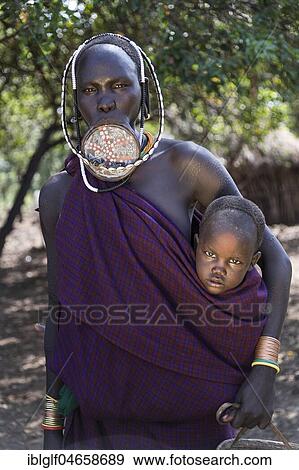 Woman with lip plate and baby, Mursi tribe, portrait, Southern Nations Nationalities and Peoples' Region, Ethiopia, Africa View Large Photo Image Stock Photo - Woman with lip plate and baby, Mursi tribe, portrait, Southern Nations Nationalities and Peoples' Region, Ethiopia, Africa. Fotosearch