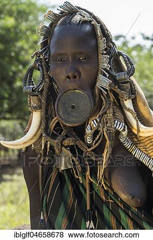 Stock Photo - Woman with lip plate and headdress, portrait, tribe of the Mursi, Southern Nations Nationalities and Peoples' Region, Ethiopia, Africa. Fotosearch