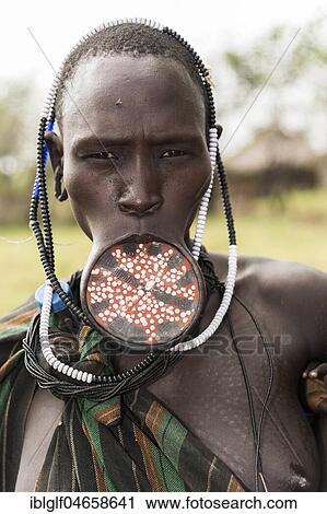 Stock Image - Woman with lip plate, portrait, tribe of the Mursi, Southern Nations Nationalities and Peoples' Region, Ethiopia, Africa. Fotosearch