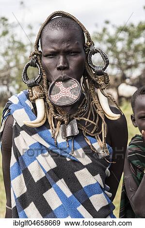 Woman with lip plate, portrait, tribe of the Mursi, Southern Nations Nationalities and Peoples' Region, Ethiopia, Africa View Large Photo Image Stock Photo - Woman with lip plate, portrait, tribe of the Mursi, Southern Nations Nationalities and Peoples' Region, Ethiopia, Africa. Fotosearch