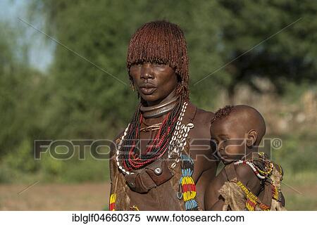 Woman with toddler, Hamer tribe, Turmi market, Southern Nations Nationalities and Peoples' Region, Ethiopia, Africa View Large Photo Image Stock Photography - Woman with toddler, Hamer tribe, Turmi market, Southern Nations Nationalities and Peoples' Region, Ethiopia, Africa. Fotosearch