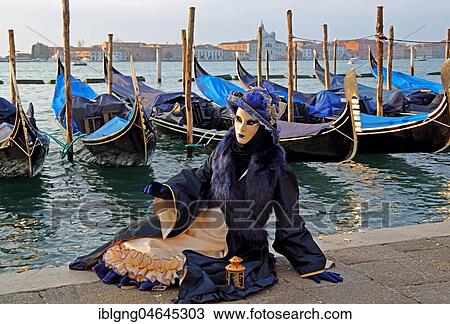 Woman with Venetian mask sitting at the lagoon, behind San Giorgio, carnival in Venice, Venice, Italy, Europe View Large Photo Image Stock Image - Woman with Venetian mask sitting at the lagoon, behind San Giorgio, carnival in Venice, Venice, Italy, Europe. Fotosearch