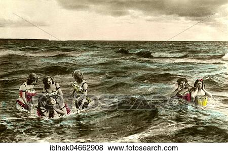 Stock Photo - Women bathing in the sea, 1910s, hand-coloured, Baltic Sea, Germany, Europe. Fotosearch
