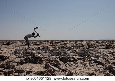 Worker in the salt desert in Dallol, Ethiopia, Africa View Large Photo Image Stock Photo - Worker in the salt desert in Dallol, Ethiopia, Africa. Fotosearch