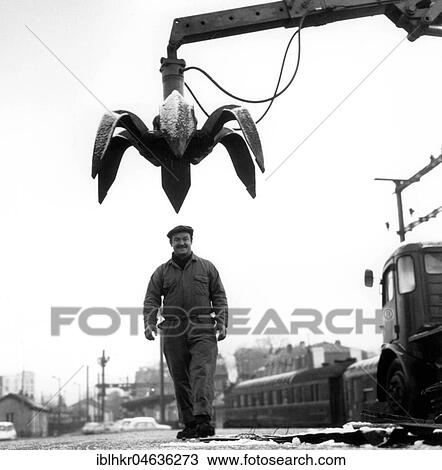 Worker under crane, ca. 1970s, exact location unknown, France, Europe View Large Photo Image Stock Image - Worker under crane, ca. 1970s, exact location unknown, France, Europe. Fotosearch