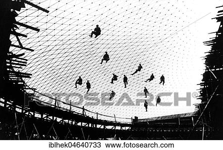 Stock Image - Workers build a net of steel, 1930s, exact place unknown, Germany, Europe. Fotosearch
